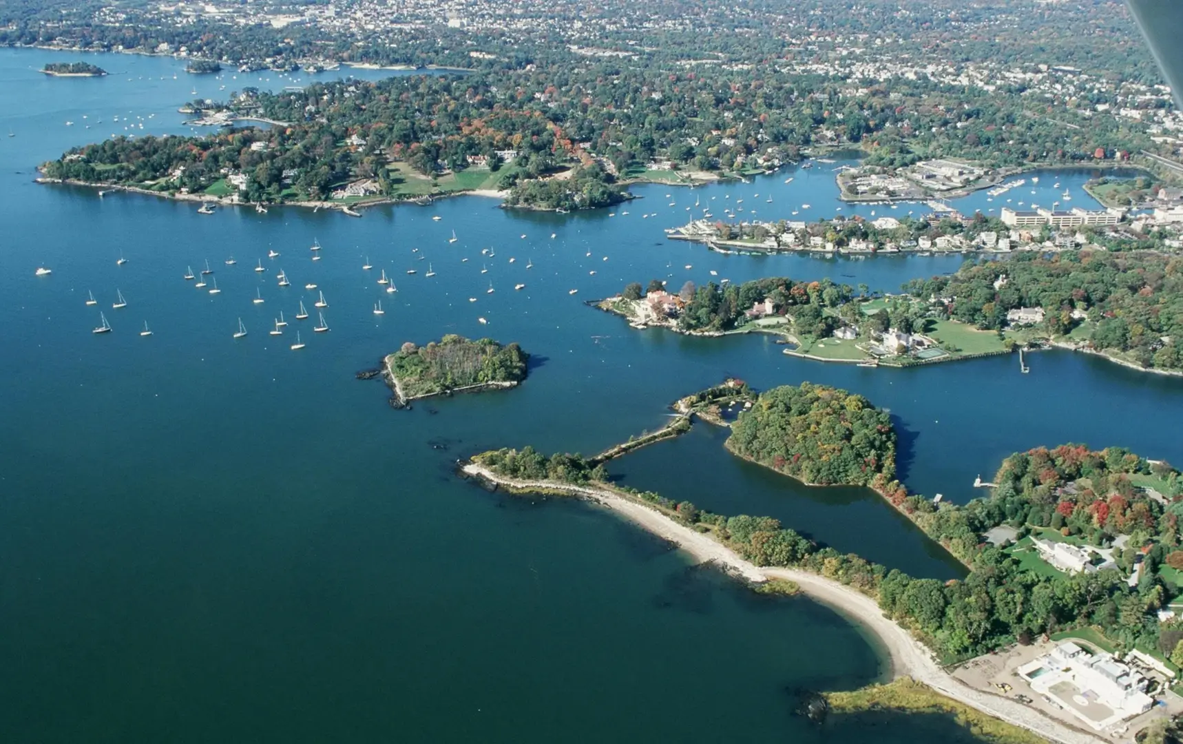 Aerial view of sailboats near coastal islands.